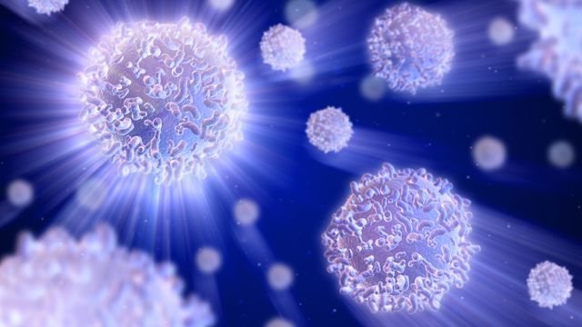 A graphic of shining T cells in a dark blue background.