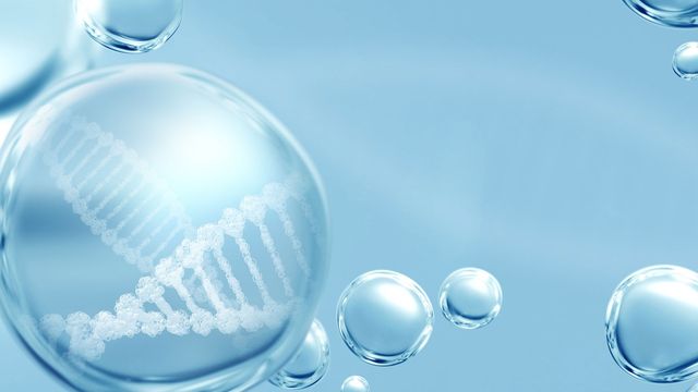 Transparent bubble containing a 3D DNA double helix strand on a light blue background.