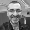 A greyscale headshot of Derek Davies