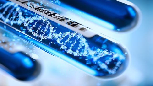Close-up of a test tube containing a DNA double helix, representing whole-genome sequencing.