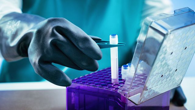 A person holding a tube, representing optimal storage conditions to preserve sample integrity.