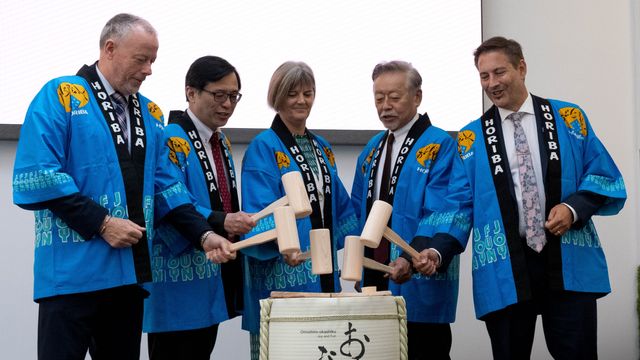Executives in traditional happi coats perform kagami-biraki at UK tech centre opening ceremony.