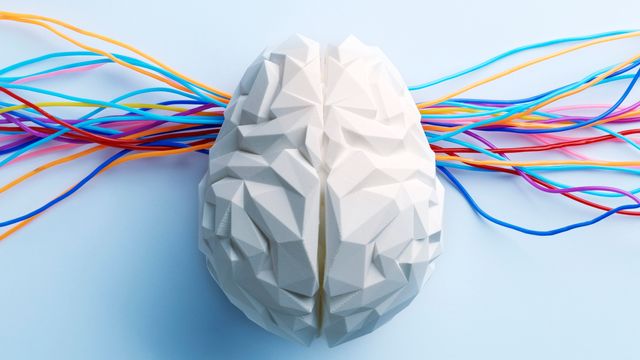 Geometric brain model with colorful wires extending outward, symbolizing neural connectivity.