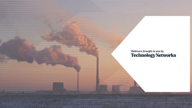 Industrial smokestacks emitting thick plumes of smoke into a hazy sky at sunset, highlighting air pollution