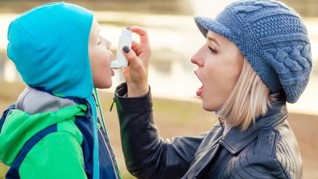 Women using a asthma inhaler