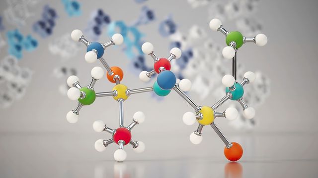 Colorful 3D molecular model representing complex chemical structure on a reflective surface