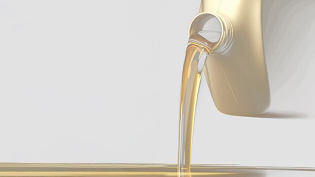 Golden biofuel being poured from a container, illustrating biodiesel purity and trace element analysis.